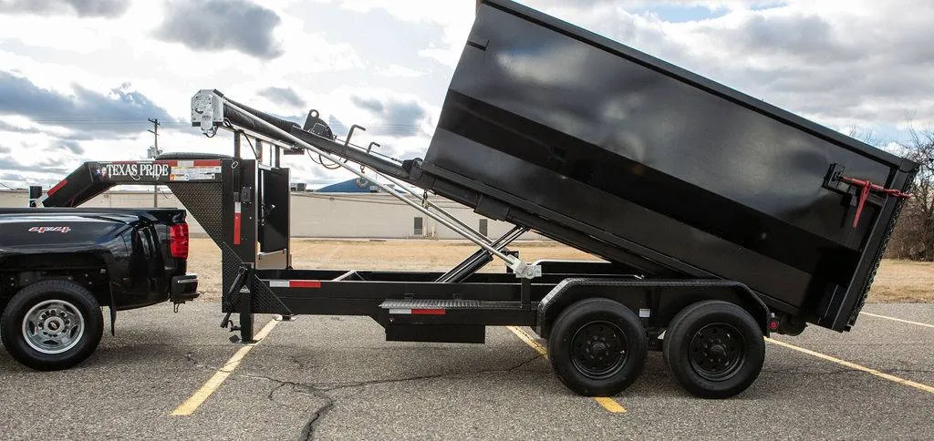 Hydraulic dump trailer raised to unload at the end of a rental