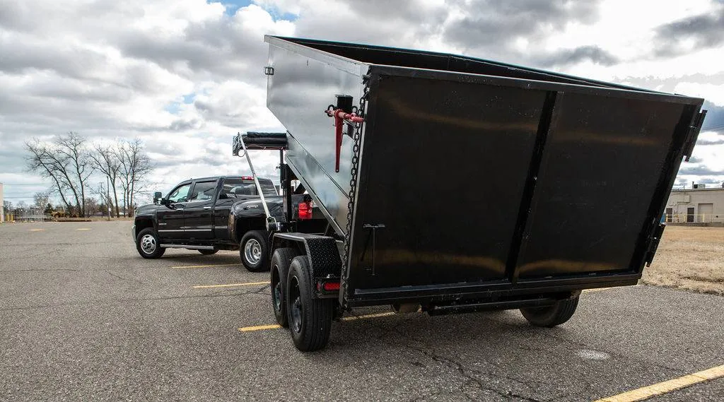 Rubber wheel dump trailer tipped up, the driveway safe alternative to a steel roll off