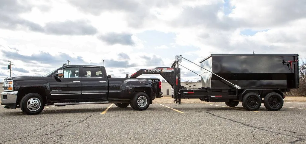 Chevrolet Silverado 3500 HD towing a gooseneck roll off dumpster trailer