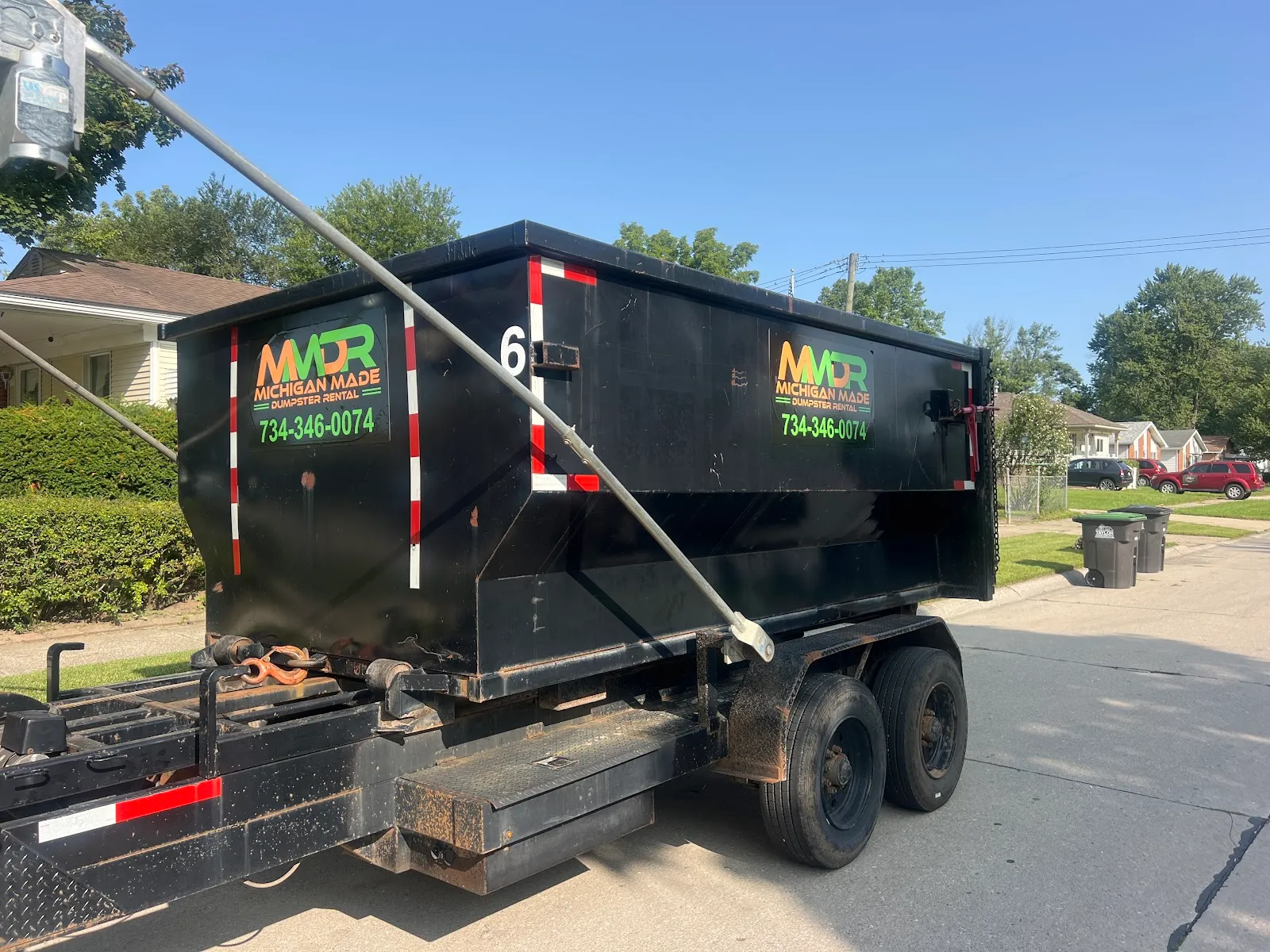Michigan Made Dumpster Rentals roll off container delivered curbside on a Wayne County residential street